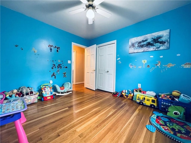 recreation room featuring a ceiling fan and wood finished floors