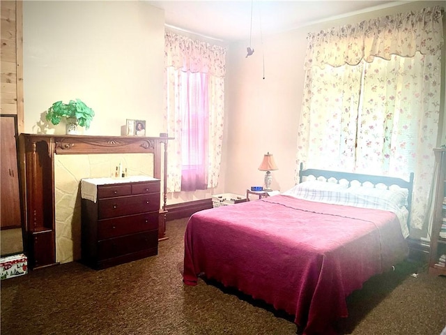bedroom with dark colored carpet
