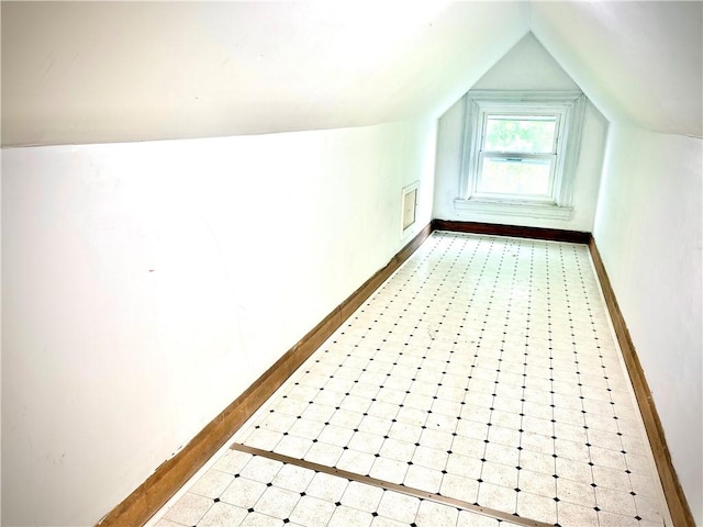 bonus room featuring vaulted ceiling and baseboards
