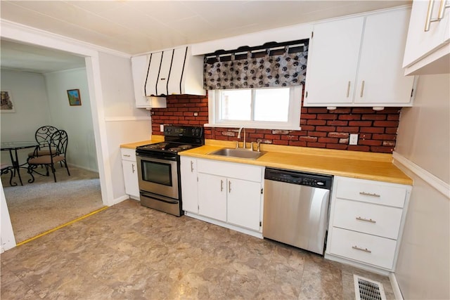 761 Dawson St, California, PA 15419 - kitchen with a sink, white cabinets, light countertops, appliances with stainless steel finishes, and ornamental molding