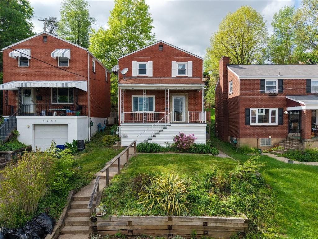 1705 Duffield St, Morningside, PA 15206 - view of front of home featuring stairs, a garage, a front lawn, and brick siding