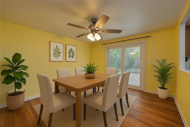 dining area with light wood-style floors, baseboards, and ceiling fan