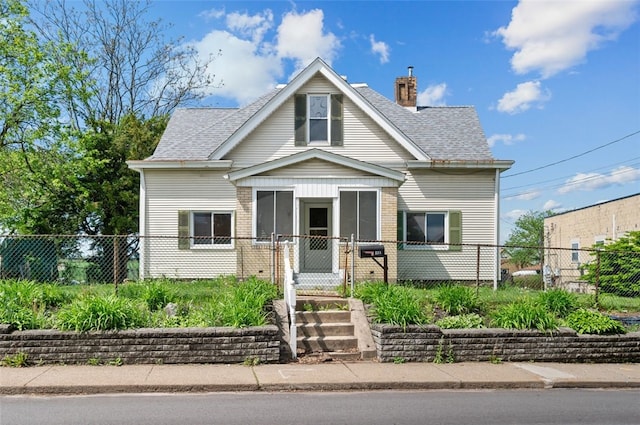 view of front facade featuring a chimney, brick siding, a shingled roof, and fence private yard