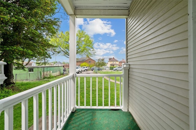 balcony featuring covered porch and a residential view