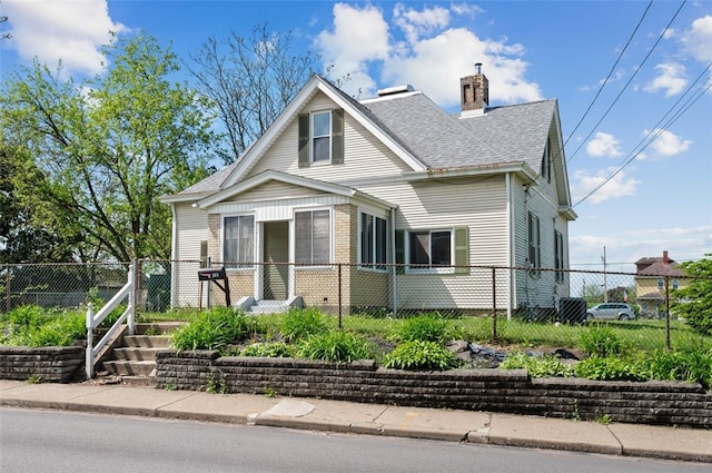 bungalow featuring roof with shingles, fence, a chimney, and brick siding