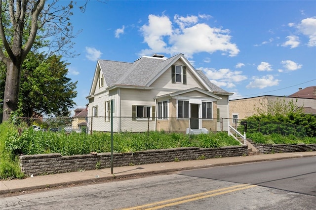 view of front of home with brick siding, a shingled roof, fence, and uncovered parking