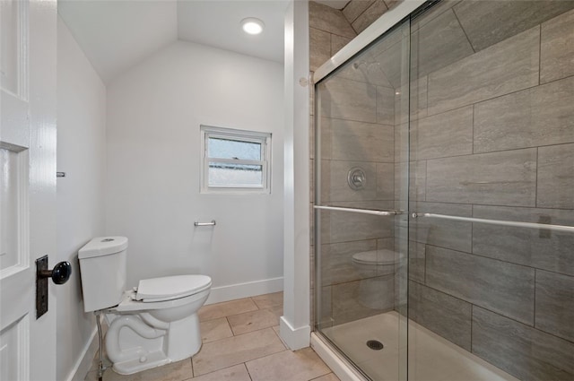 bathroom featuring tile patterned flooring, toilet, baseboards, and a shower stall