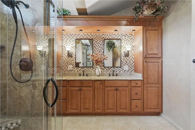 bathroom featuring a sink, double vanity, and a shower stall