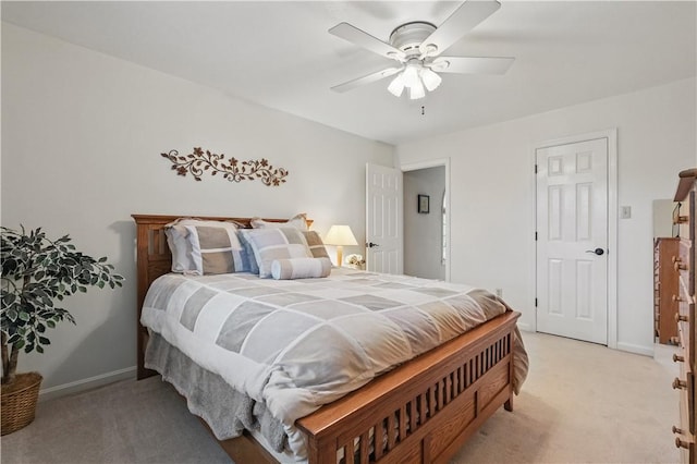bedroom featuring baseboards, light carpet, and ceiling fan