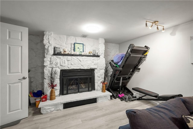 1306 Cochran Rd, Mt Lebanon, PA 15243 - exercise area featuring wood finished floors and a stone fireplace