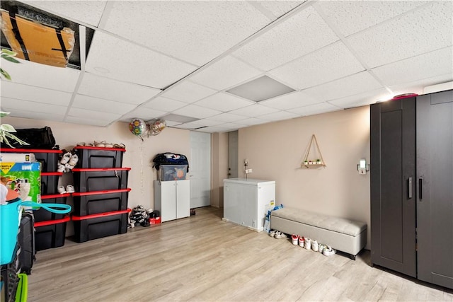 1306 Cochran Rd, Mt Lebanon, PA 15243 - finished basement featuring wood finished floors, a paneled ceiling, and fridge