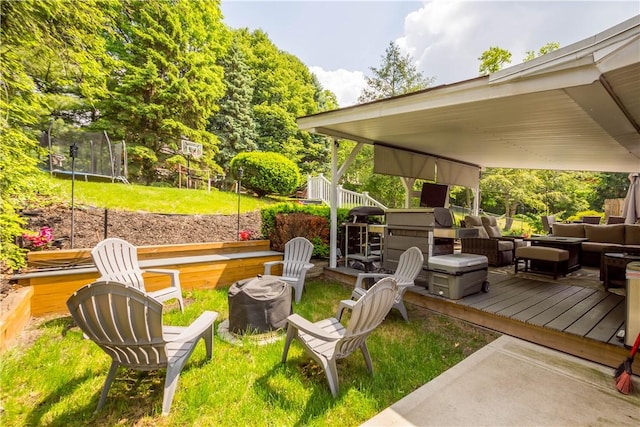 1306 Cochran Rd, Mt Lebanon, PA 15243 - view of grassy yard with a trampoline, an outdoor hangout area, and a wooden deck