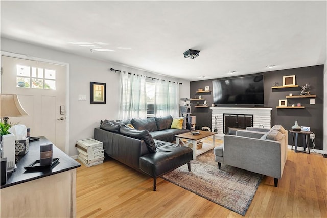 1306 Cochran Rd, Mt Lebanon, PA 15243 - living room with healthy amount of natural light, light wood-style floors, and a fireplace