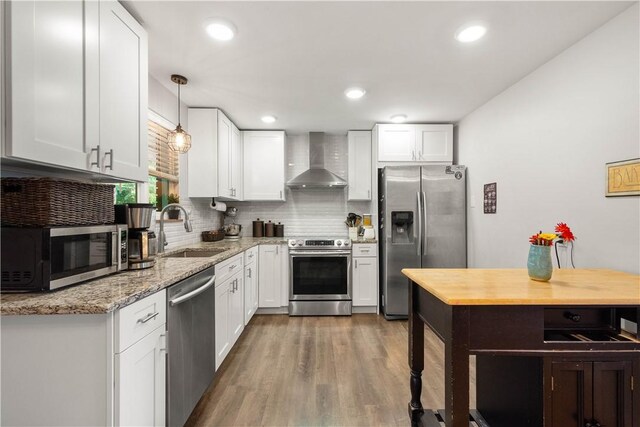 1306 Cochran Rd, Mt Lebanon, PA 15243 - kitchen with appliances with stainless steel finishes, a sink, wall chimney range hood, tasteful backsplash, and white cabinets