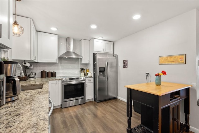 1306 Cochran Rd, Mt Lebanon, PA 15243 - kitchen featuring stainless steel appliances, wall chimney exhaust hood, white cabinets, decorative backsplash, and dark wood finished floors