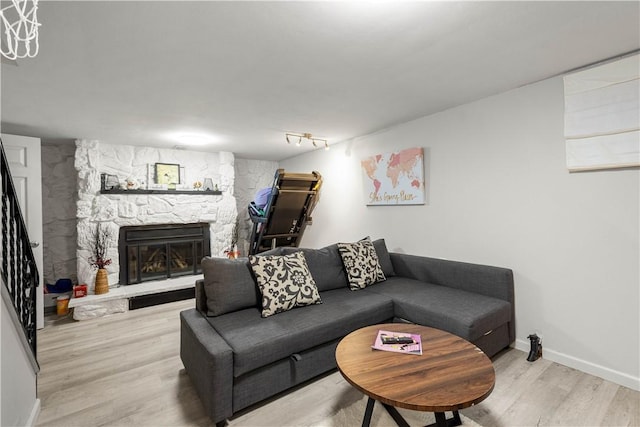 1306 Cochran Rd, Mt Lebanon, PA 15243 - living area featuring a stone fireplace, wood finished floors, and baseboards
