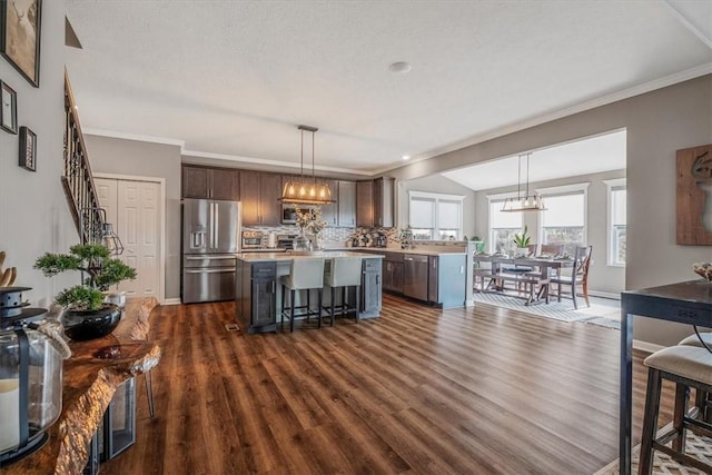 2623 Arno Dr, Oakdale, PA 15071 - kitchen featuring stainless steel appliances, a breakfast bar area, dark wood finished floors, light countertops, and a kitchen island