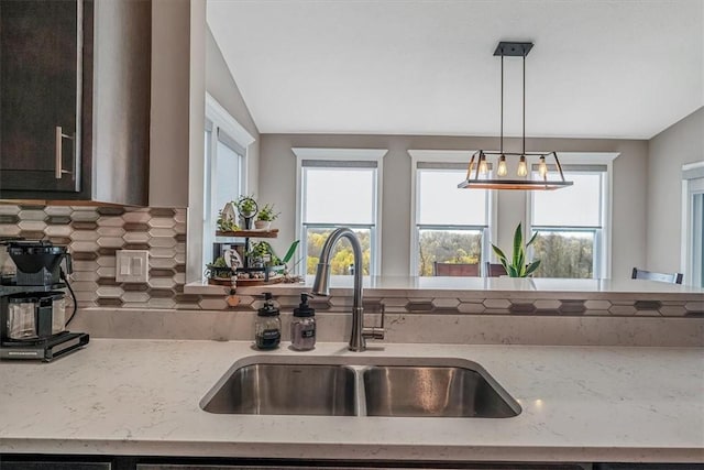 2623 Arno Dr, Oakdale, PA 15071 - kitchen with a sink, a wealth of natural light, tasteful backsplash, decorative light fixtures, and light stone counters
