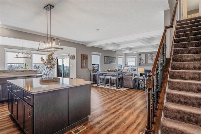 2623 Arno Dr, Oakdale, PA 15071 - kitchen featuring open floor plan, a kitchen island, light countertops, wood finished floors, and beam ceiling