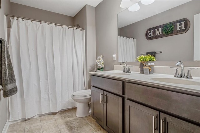 2623 Arno Dr, Oakdale, PA 15071 - full bathroom with double vanity, tile patterned floors, toilet, and a sink