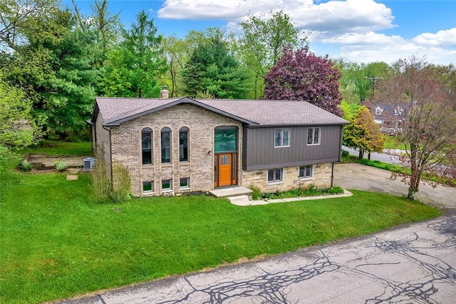 43 Mckrell Rd, West Deer, PA 15076 - raised ranch with central air condition unit, brick siding, a chimney, and a front yard