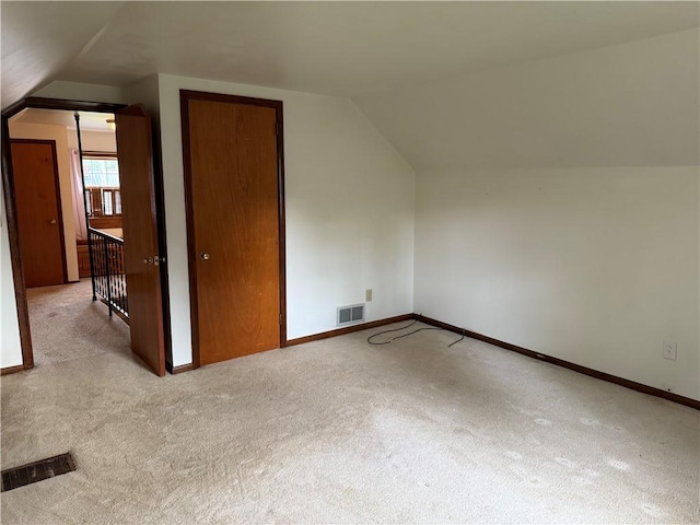 additional living space featuring carpet, vaulted ceiling, and visible vents
