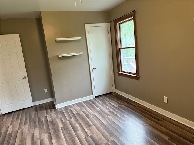 interior space featuring wood finished floors and baseboards