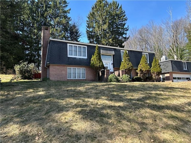 219 Meadow Dr, Westmont Hilltop School District, PA 15905 - view of front of house with brick siding, a front lawn, a chimney, and mansard roof