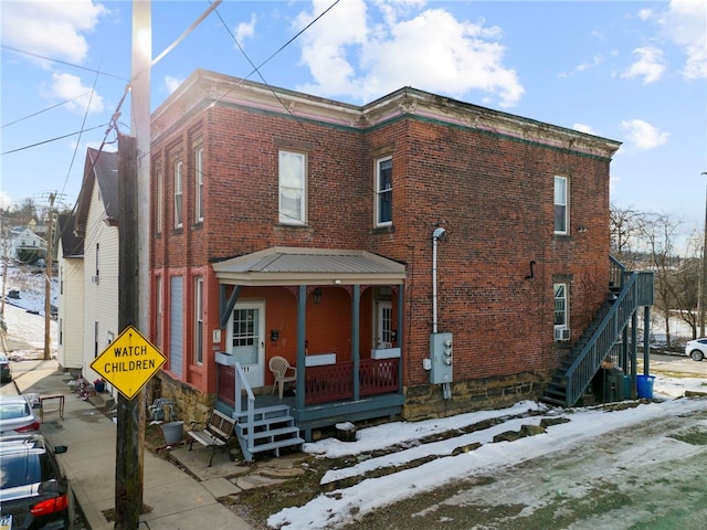209-211 S Wade St, City Of Washington, PA 15301 - view of front of house featuring covered porch, brick siding, and stairs