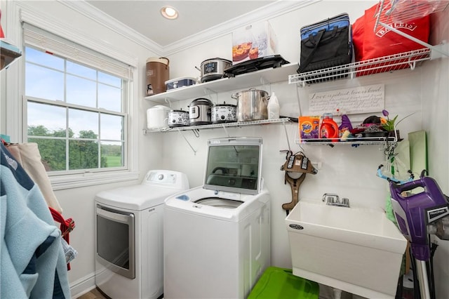 washroom featuring laundry area, recessed lighting, ornamental molding, a sink, and separate washer and dryer