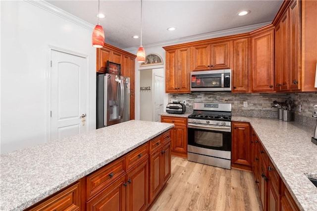 kitchen featuring brown cabinetry, crown molding, decorative light fixtures, appliances with stainless steel finishes, and decorative backsplash