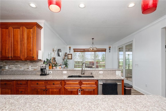 kitchen featuring stainless steel dishwasher, ornamental molding, an inviting chandelier, a sink, and decorative backsplash