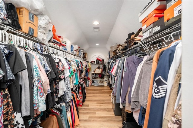 spacious closet with vaulted ceiling and wood finished floors