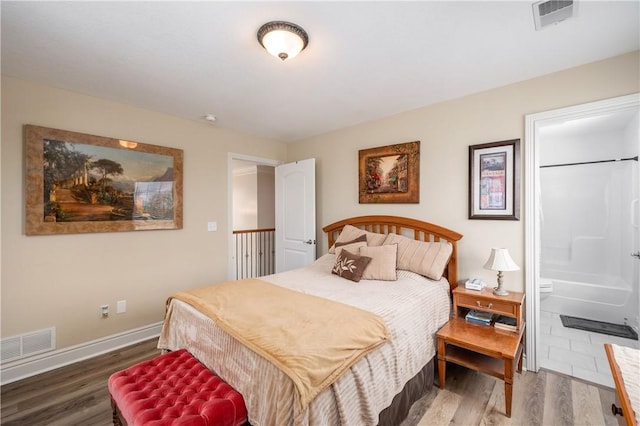 bedroom featuring visible vents, wood finished floors, and baseboards