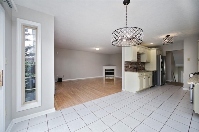 1004 Augusta Ln, Penn Twp Wml, PA 15644 - kitchen with freestanding refrigerator, open floor plan, light tile patterned flooring, dishwashing machine, and baseboards