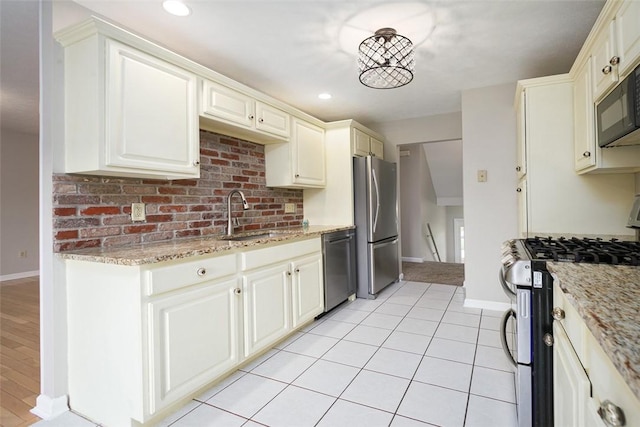 1004 Augusta Ln, Penn Twp Wml, PA 15644 - kitchen featuring appliances with stainless steel finishes, a sink, baseboards, light stone counters, and recessed lighting