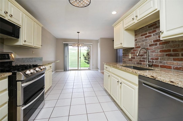 1004 Augusta Ln, Penn Twp Wml, PA 15644 - kitchen with light tile patterned floors, a sink, baseboards, light stone countertops, and appliances with stainless steel finishes