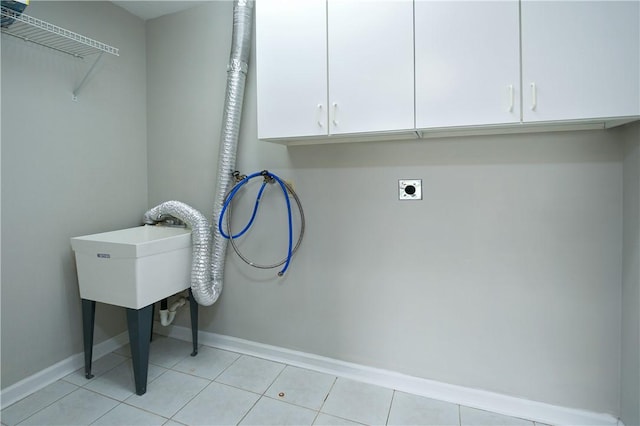 1004 Augusta Ln, Penn Twp Wml, PA 15644 - laundry area with electric dryer hookup, cabinet space, baseboards, and light tile patterned floors