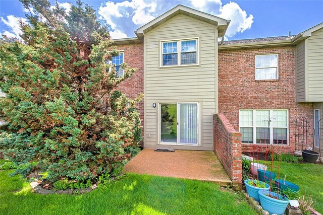 1004 Augusta Ln, Penn Twp Wml, PA 15644 - rear view of property featuring brick siding, a yard, and a patio