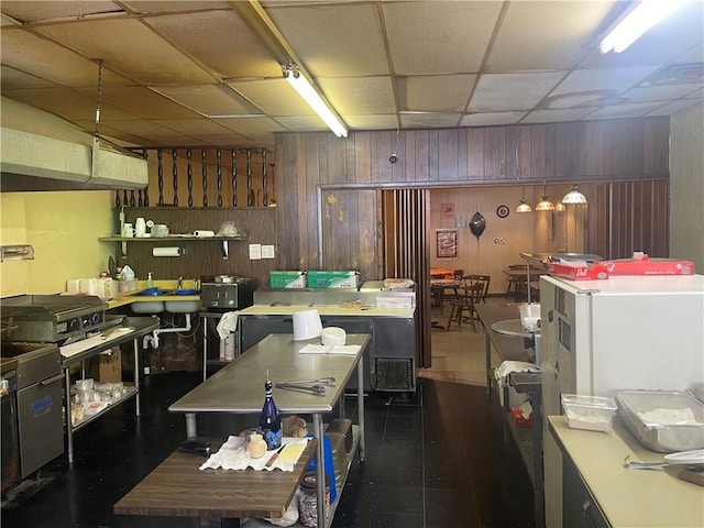 557 Mckean Ave, Donora, PA 15033 - kitchen featuring wooden walls, a drop ceiling, and light countertops