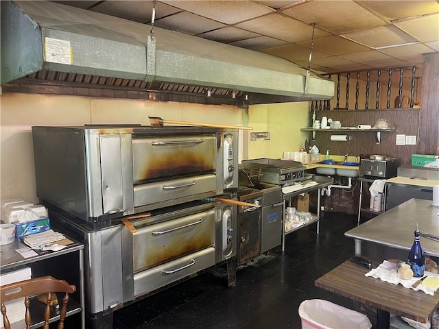 557 Mckean Ave, Donora, PA 15033 - kitchen with open shelves, tile patterned floors, a drop ceiling, and wooden walls