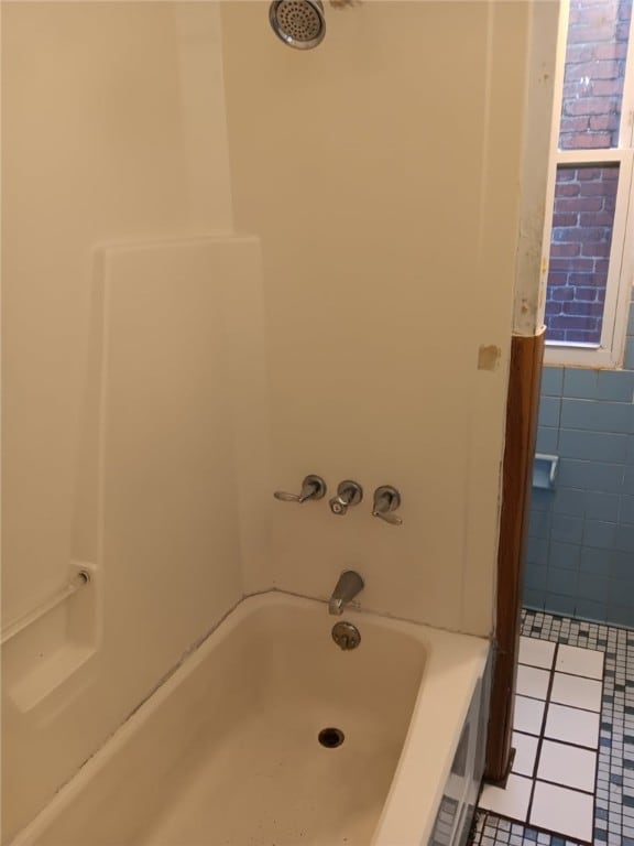 557 Mckean Ave, Donora, PA 15033 - bathroom featuring tile patterned flooring and washtub / shower combination