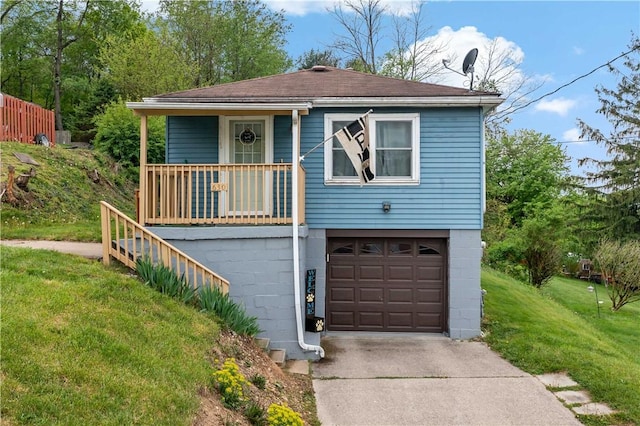 view of front of home with driveway, covered porch, an attached garage, roof with shingles, and a front lawn