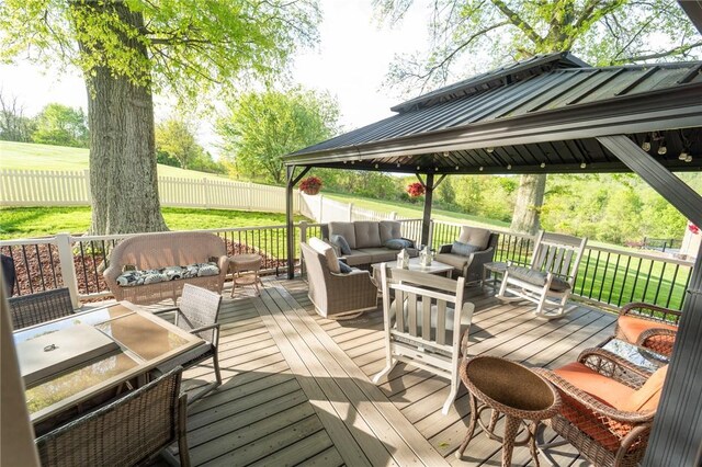 wooden terrace featuring an outdoor living space and a gazebo