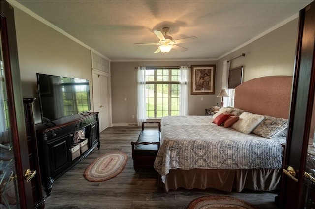 bedroom featuring ornamental molding, dark wood finished floors, baseboards, and ceiling fan