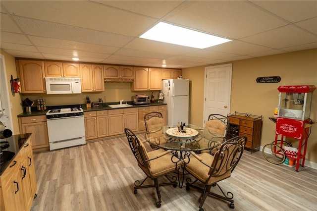 dining room featuring a paneled ceiling and light wood-style floors