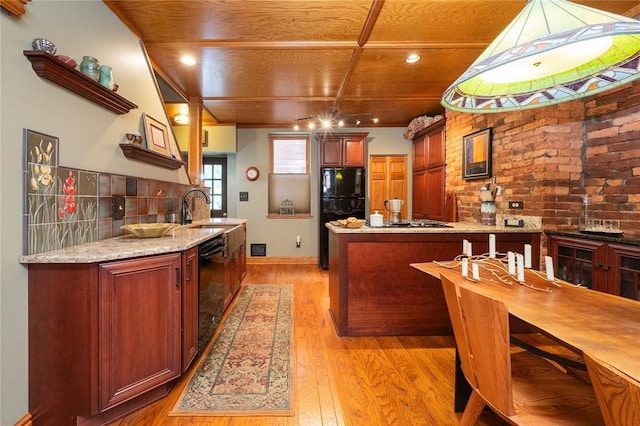 2220 Sarah St, South Side, PA 15203 - kitchen featuring light wood-style flooring, black appliances, a peninsula, wood ceiling, and brick wall