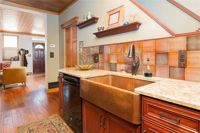 2220 Sarah St, South Side, PA 15203 - kitchen featuring black dishwasher, crown molding, wood-type flooring, a sink, and tasteful backsplash
