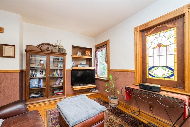 2220 Sarah St, South Side, PA 15203 - sitting room with wood finished floors and a wainscoted wall