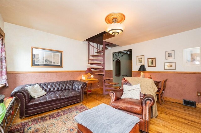 2220 Sarah St, South Side, PA 15203 - living area featuring stairs, wainscoting, and wood finished floors